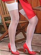 Mature in High Heels and Shiny White Stockings In The Garden