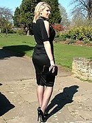 Gorgeous blonde MILF wearing a pretty black blouse and skirt, with matching pantyhose and tall stiletto heels